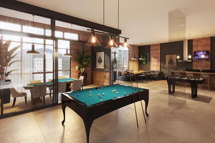 Indoor games room with a pool table, foosball and lounge seating
